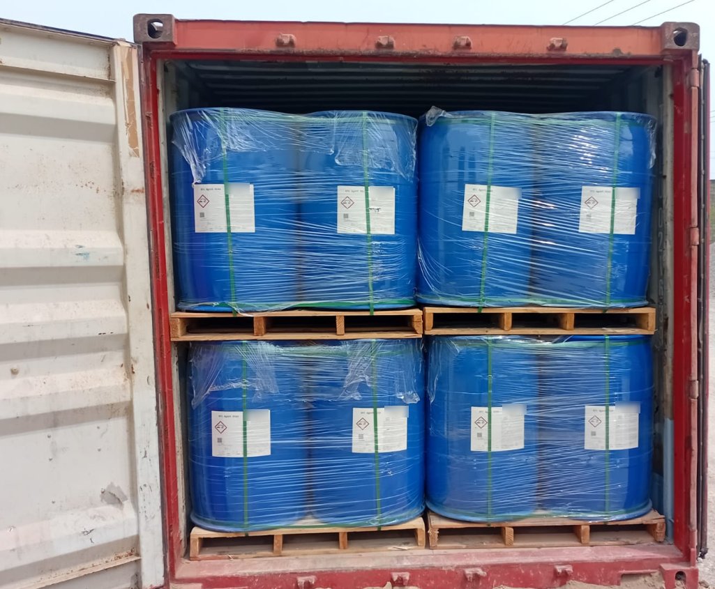 Shrink-wrapped, palletised chemical drums loaded in a shipping container