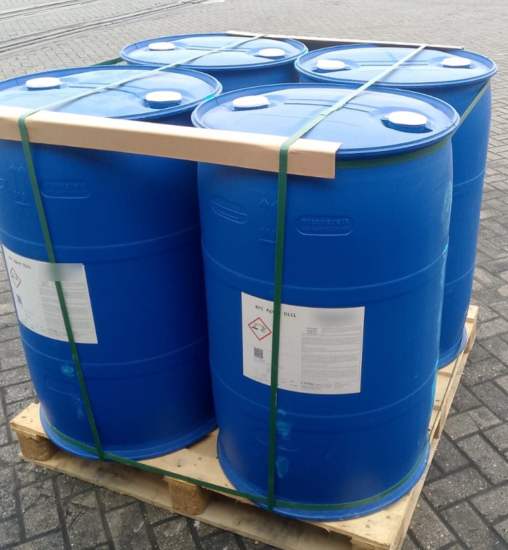 Four labelled blue chemical drums strapped to a wooden pallet