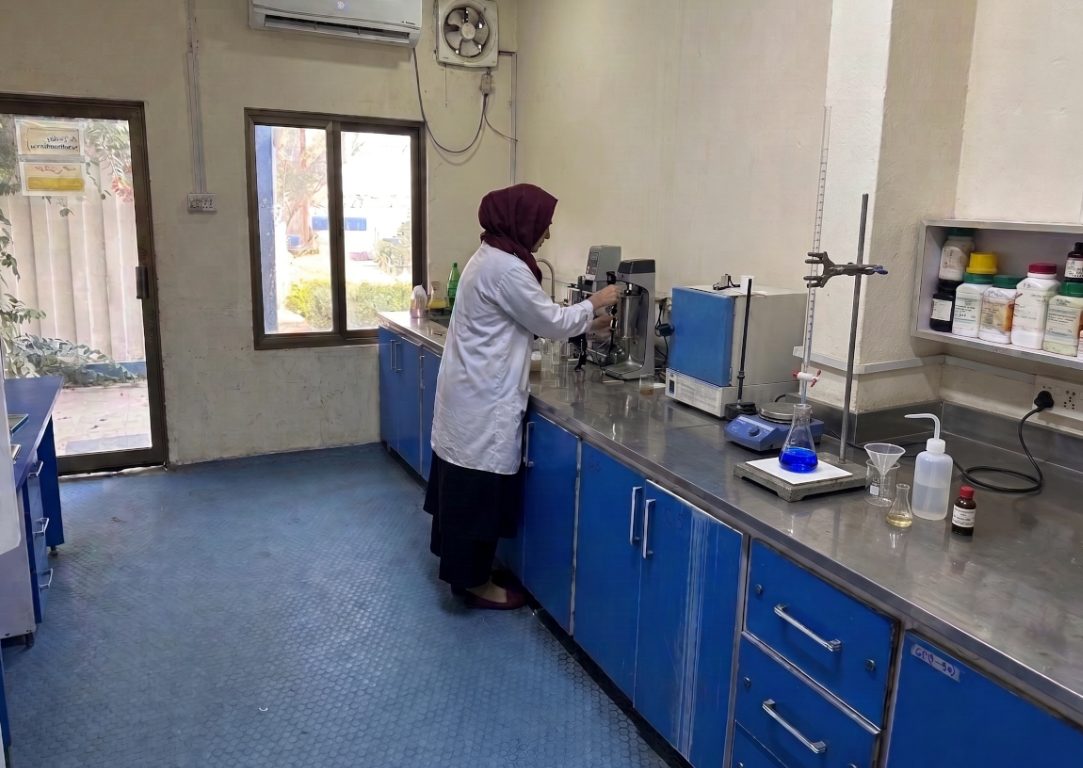 Chemist operating equipment at a laboratory bench