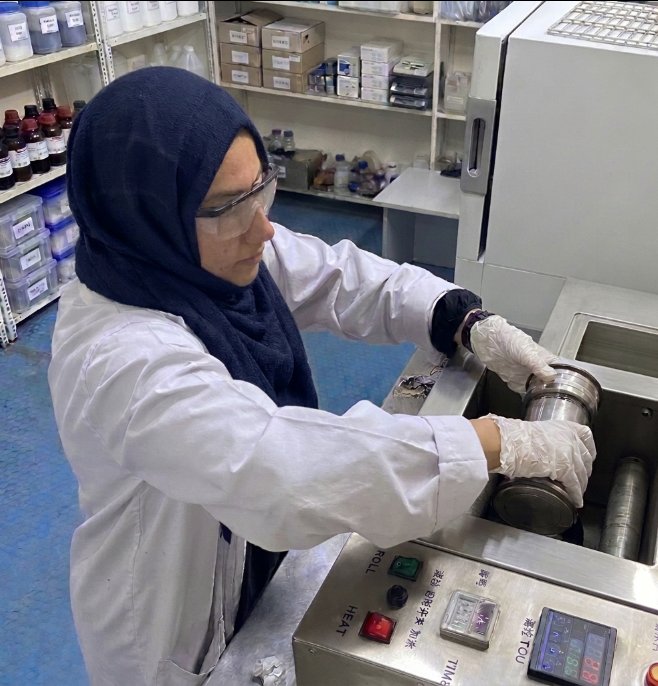 Redox chemist loading an aging cell into a roller oven for drilling fluid testing