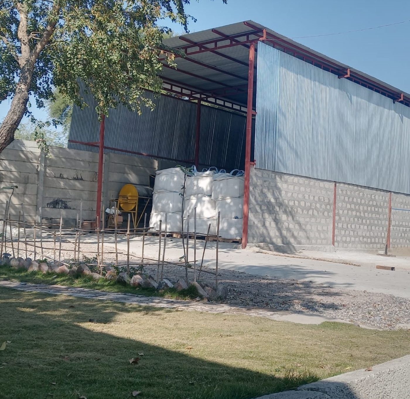 Covered storage shed with bulk bags of raw material
